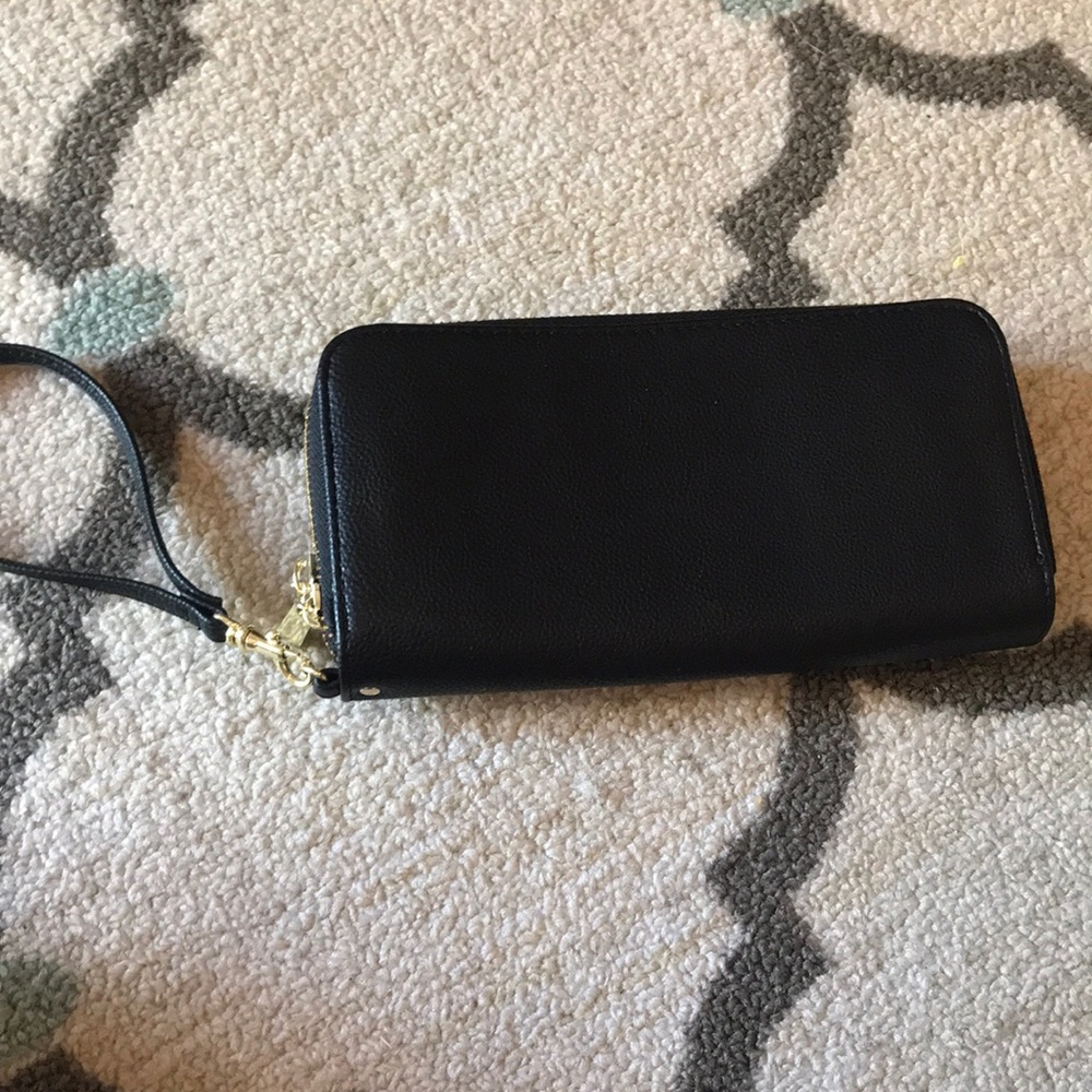 Black wristlet with gold zippers